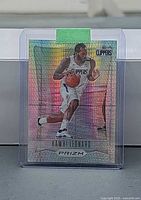 Front view of Kawhi Leonard Hyper Prizm card inside sleeve and top loader