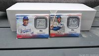Front view of both sealed 2021 Topps 70th Anniversary Patch cards featuring Jackie Robinson and Ernie Banks