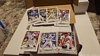 Open card storage box showing stacks of 2022 Topps Holiday baseball cards and several sample cards displayed on top