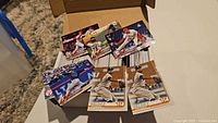 Open box showing stacks of trading cards with six cards displayed on top, including three Framber Valdez rookie cards