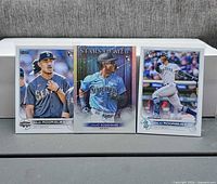 Front view of three Julio Rodriguez rookie cards standing upright on display