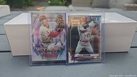 Front view of both Shohei Ohtani Topps Stars of MLB and Bowman cards in protective sleeves