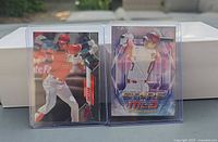 Two Shohei Ohtani Topps baseball cards in toploaders