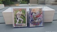Front view of both Shohei Ohtani Bowman and Topps Stars of MLB cards in protective holders