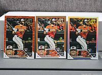 Front view of three Kyle Stowers 2023 Topps rookie parallel cards