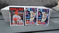 Front view of three Bryce Harper Topps baseball cards arranged side by side