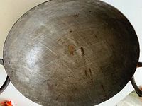 Top view of wok interior showing wear and rust spots