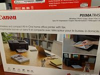 Retail box showing Canon PIXMA TR4527 printer and feature list