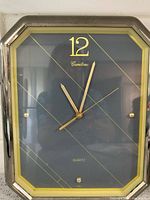 Front view showing octagonal chrome frame, dial design, hands and numeral