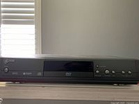 front view of GE slim DVD player on shelf