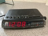 Front view showing red LED time display and AM/FM scale