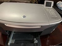 Front three-quarter view showing body, LCD panel and partial output tray