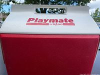 Front view of Igloo Playmate cooler showing red body, white lid, logo and handle