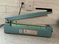 Left-side profile showing full unit and power cord