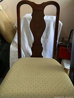 Front view of chair showing splat back and upholstery