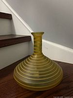 Front angle of amber frosted glass vase showing pinstripe pattern and bulbous form