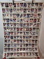 Entire uncut sheet hanging, showing full grid of card images