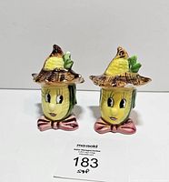Front view of both anthropomorphic corn cob shakers