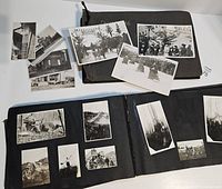 Both albums open showing mounted photographs and loose snapshots