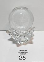 Globe paperweight on star-shaped stand