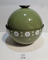 Full view of spherical green fondue pot showing lotus band