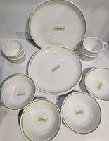 Full set laid out showing plates, bowls, mugs