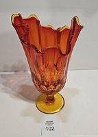 Front angled view of Amberina pedestal vase showing color gradient and ruffled rim
