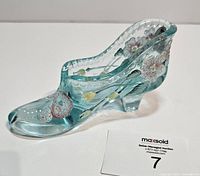 side profile of turquoise glass shoe with painted flowers