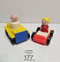 Front view of both Little People figures seated in vehicles