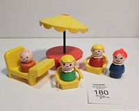 Overall view of picnic set with figures seated and umbrella