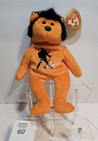 Front view of orange Elvis plush bear with Ty tag and printed silhouette logo