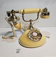 Full view of cream and gold rotary phone assembled