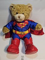 Full view of bear in Superman costume
