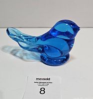 Side view of blue glass bird figurine