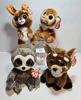 Front view of four Ty Beanie Boos plush animals