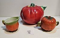 Front view of tomato teapot, sugar bowl and creamer