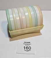 Stacked coasters in holder front view