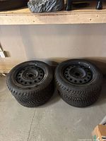 Stack of four Uniroyal winter tires on rims