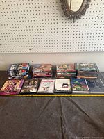 Overall lot view showing three stacks of DVD cases and five single cases in front