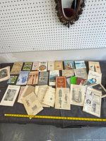 Overview of entire lot of assorted advertisements, pamphlets and booklets laid out on table