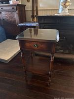 Full view of nightstand showing glass top, drawer, legs and shelf