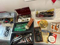 overview of all toolboxes, bins and packaged hardware on table