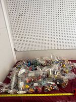 Overview of numerous zip bags filled with assorted figurines on a surface