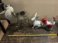 Overview of all three metal lawn ornaments with measuring tape for scale