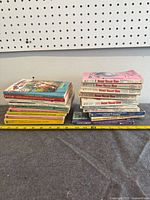 Entire lot showing two main stacks of paperbacks