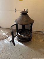 Full view of steel patio fire pit with door open