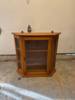 Front view of wood and glass wall cabinet