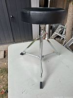 Full view of drum throne showing seat and tripod base