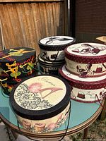 Group of seven decorative hat boxes on table