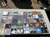 Full layout of approximately 40 CDs on table